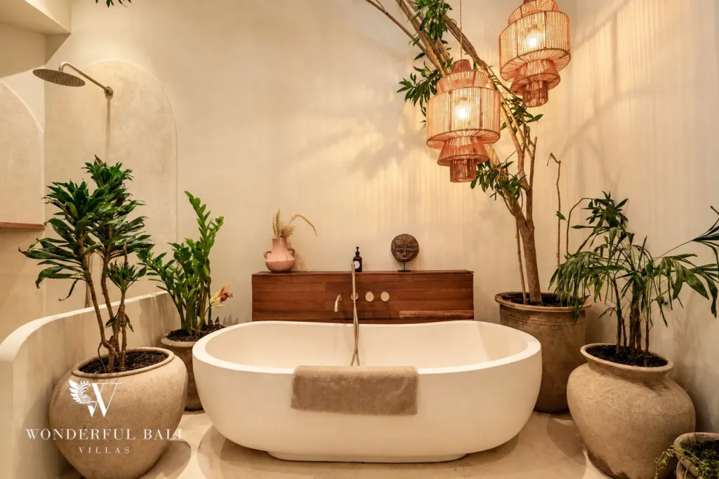 3BR villa for sale in Berawa — bathroom, stone freestanding bathtub framed by potted plants