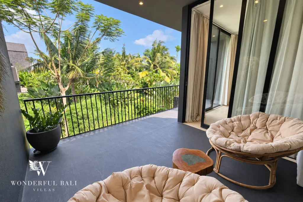 4BR villa for rent in Berawa, Canggu — terrace, papasan chairs on the upper balcony over the greenery