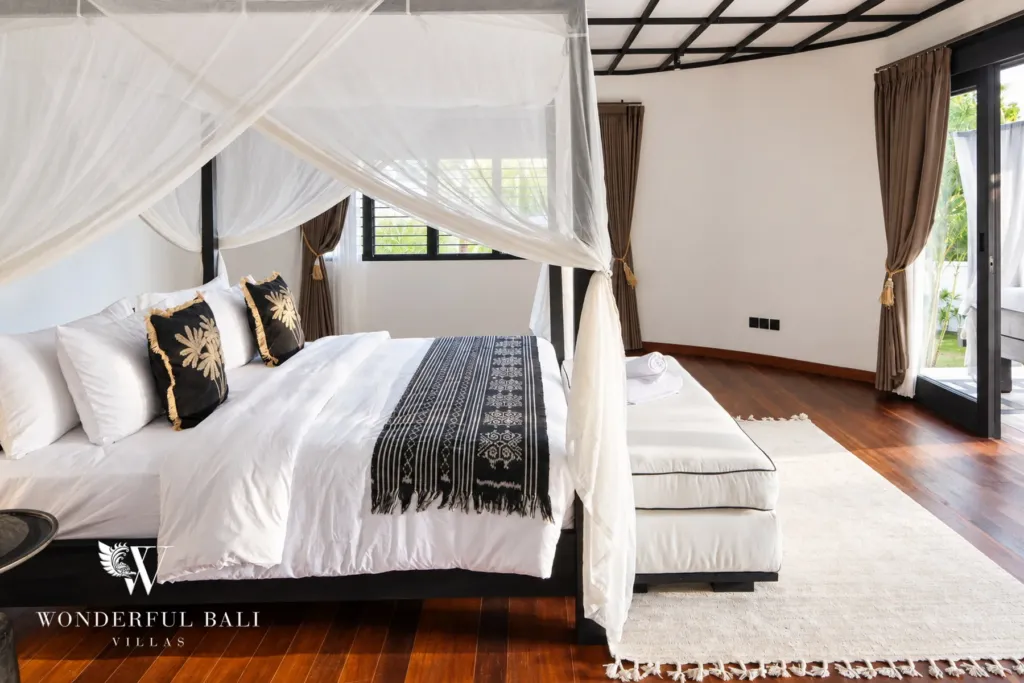 5BR villa for rent in Munggu, Bali — bedroom, canopy bed with a chaise longue in the corner by the window