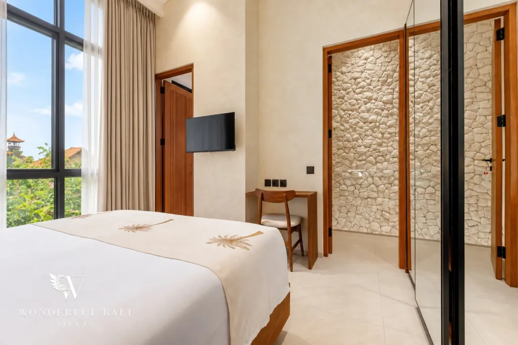 2BR villa for rent in Padonan, Canggu — bedroom, bedroom with a desk and stone-clad doorway