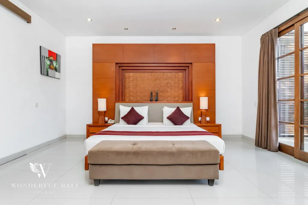 3BR villa for rent in Batu Belig, Seminyak — bedroom, king bed and timber-framed doors out to the balcony