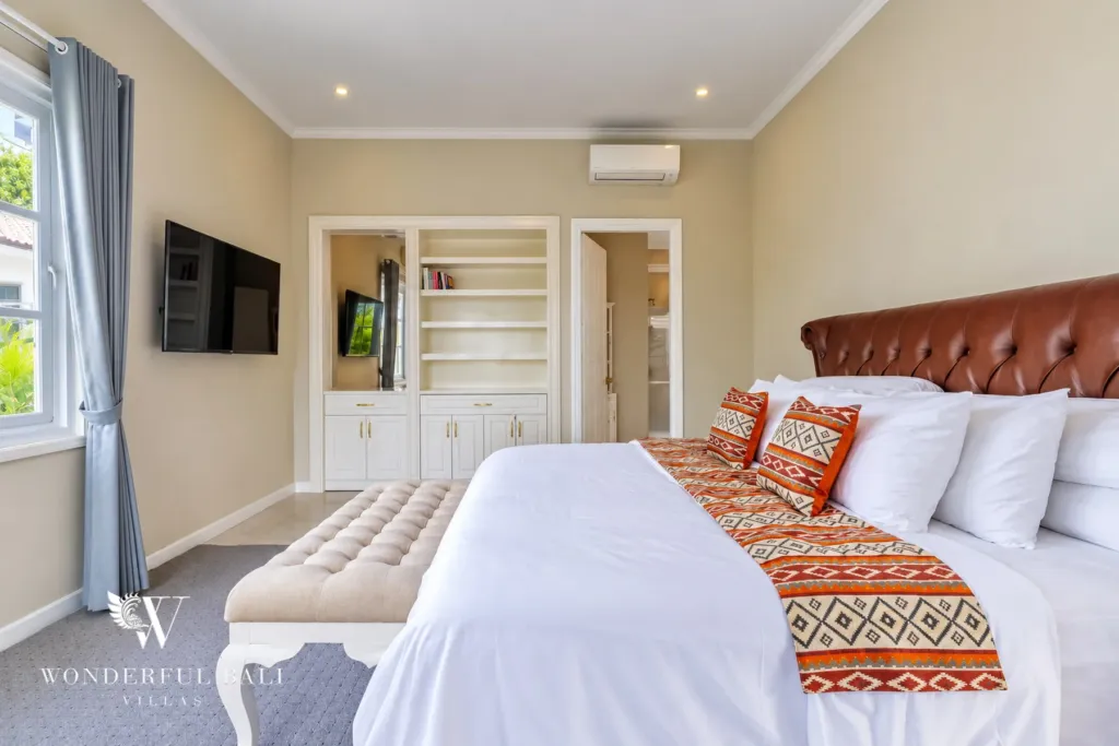 5BR villa for sale in Pererenan — bedroom with leather headboard, wall TV and built-in shelves