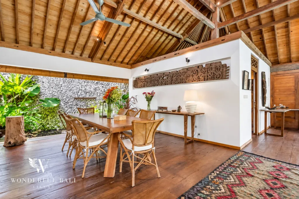 5BR villa for rent in Umalas — dining, long teak dining table beside the kitchen and garden wall