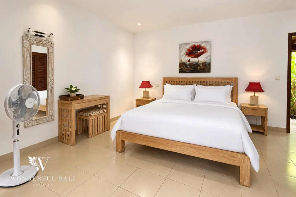 3BR villa for rent in Padonan, Canggu — bedroom, wide view of the main bedroom with air conditioning and TV