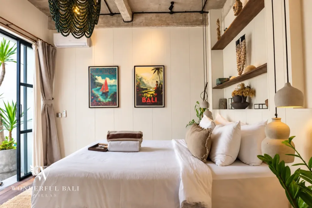 2BR villa for rent in Berawa, Canggu — bedroom, bed set behind a timber batten screen with a framed print above