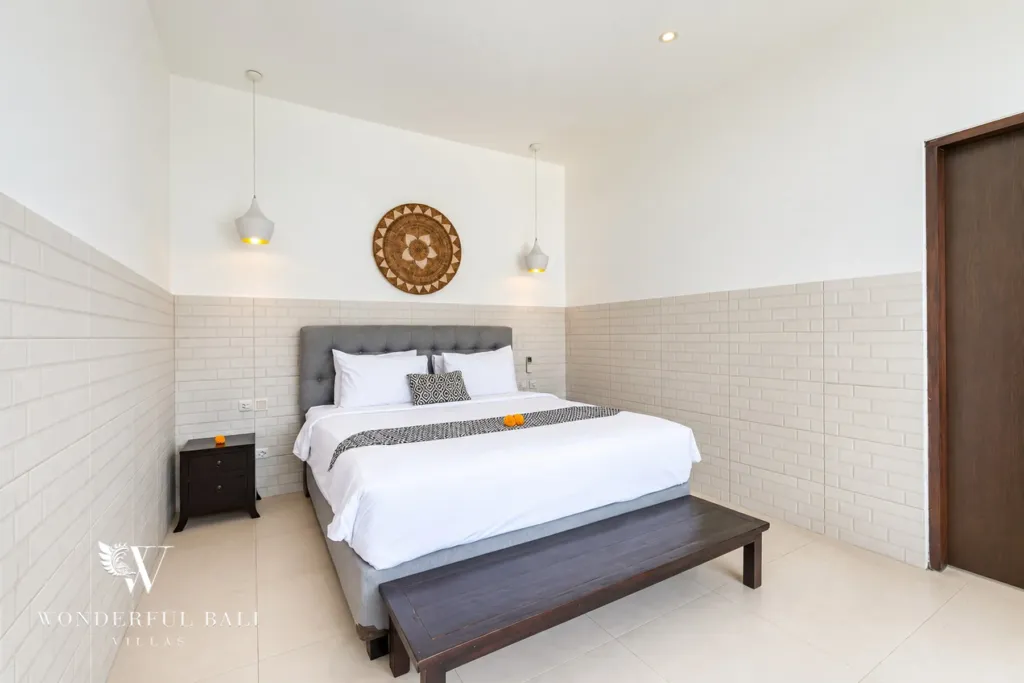 3BR villa in Berawa, Canggu, Bali — bedroom, third bedroom with a woven wall disc and bench