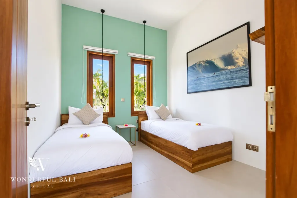 4BR villa for rent in Cemagi — bedroom, two single beds with a mint feature wall