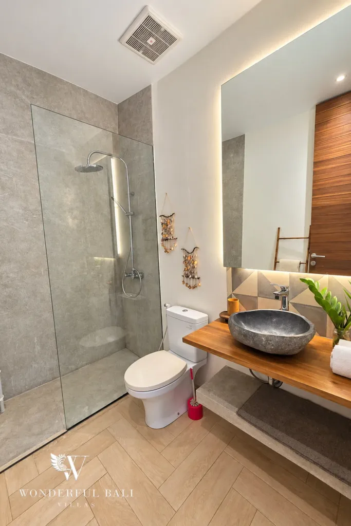 4BR villa for rent in Berawa, Canggu — bathroom, stone basin on a timber counter beside the shower