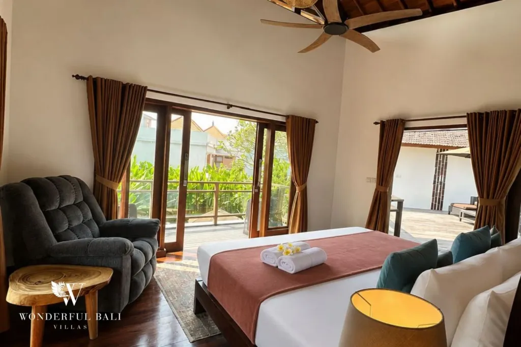 4BR villa for rent in Padonan, Canggu — bedroom 1, balcony doors and an armchair