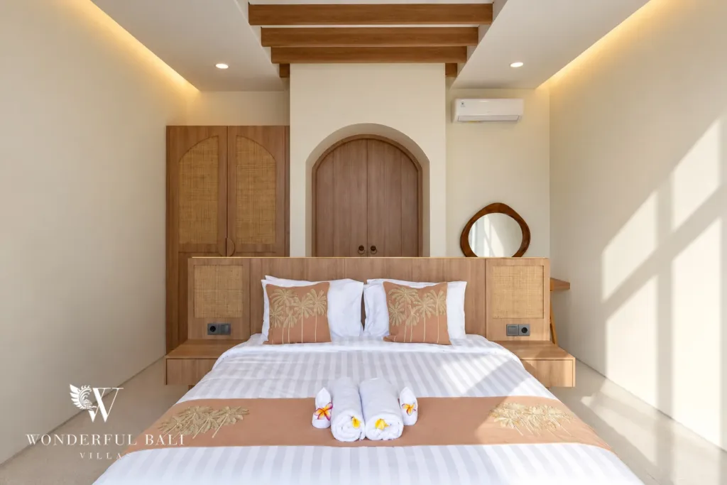 3BR villa for rent in Berawa, Canggu — bedroom, bedroom with a rattan wardrobe and round mirror