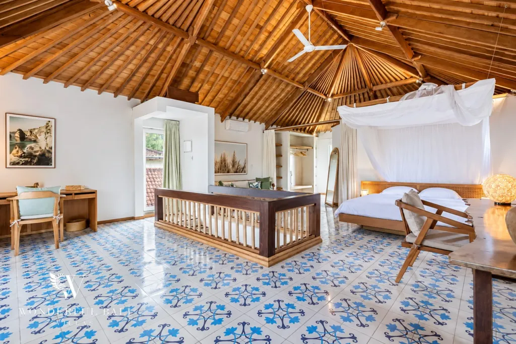 5BR villa for rent in Umalas — bedroom, canopy bed under an exposed teak roof with a mezzanine rail