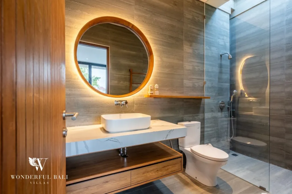 3BR villa for rent in Seminyak — bathroom 2, backlit round mirror, vessel basin and walk-in shower