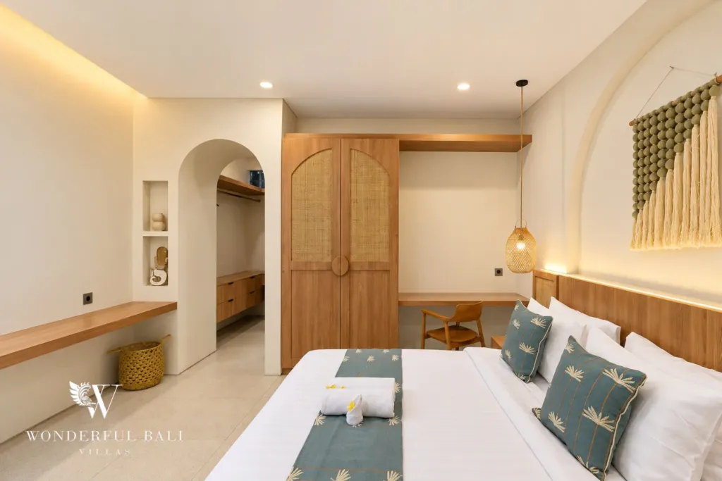 3BR villa for rent in Berawa, Canggu — bedroom, bedroom with arched timber wardrobe doors and a bench