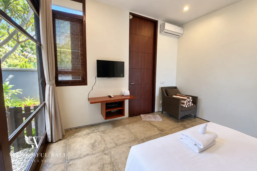 3BR villa for sale in Jimbaran — bedroom, bedroom with a TV, armchair and garden-facing window