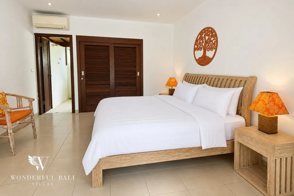 3BR villa for rent in Padonan, Canggu — bedroom, guest bedroom with console table and framed frangipani print