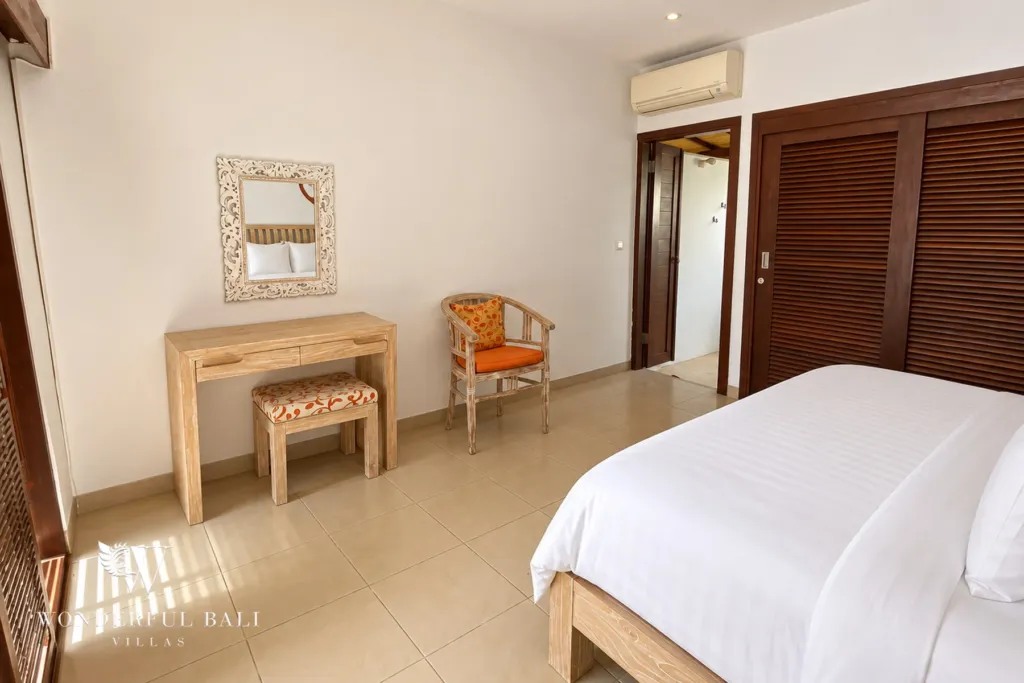 3BR villa for rent in Padonan, Canggu — bedroom, dressing corner with mirror and timber console beside the bed