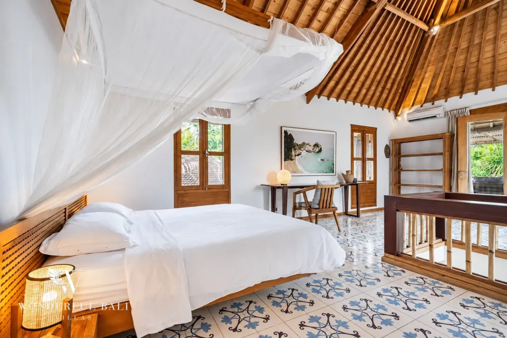 5BR villa for rent in Umalas — bedroom, white canopy bed and air conditioning under the timber roof
