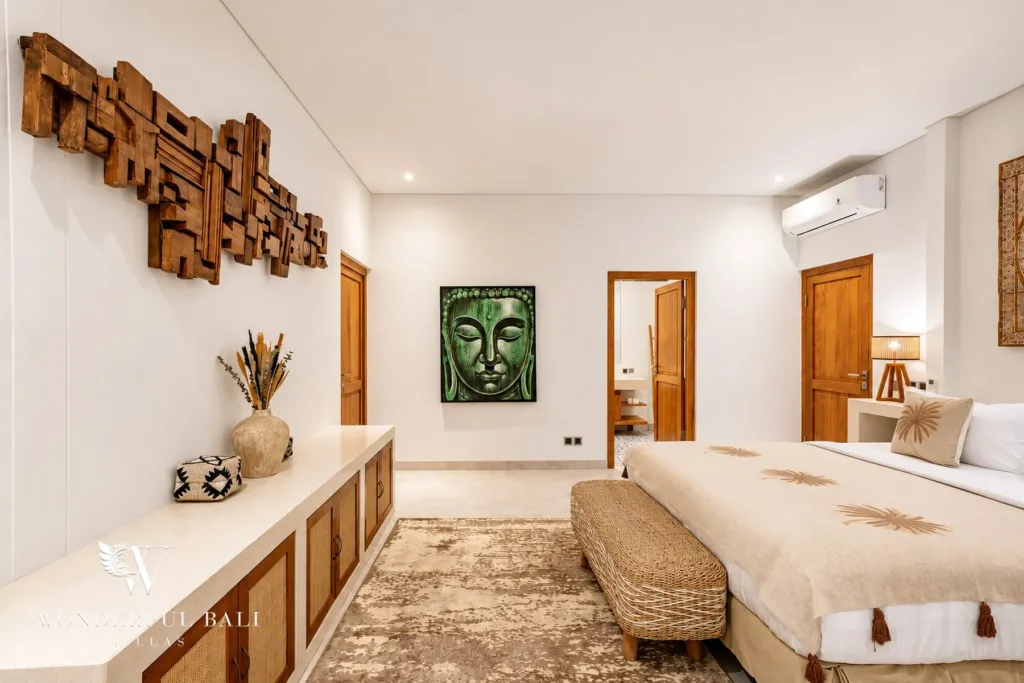 5BR villa for rent in Bumbak, Umalas — bedroom, bedroom with a bench seat and carved timber wall art