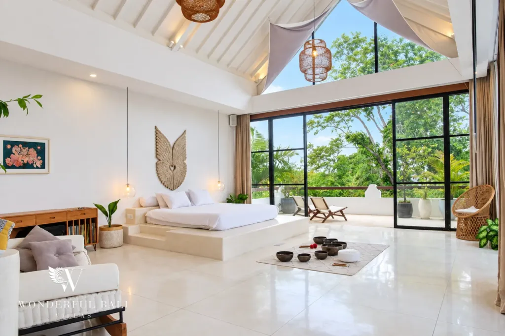 5BR villa for rent in Seseh, Bali — bedroom, wide view of the master bedroom with full-height glass to the balcony