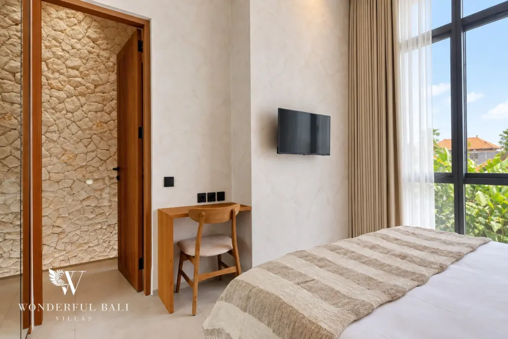 2BR villa for rent in Padonan, Canggu — bedroom, bedroom with a TV, desk and stone-clad doorway