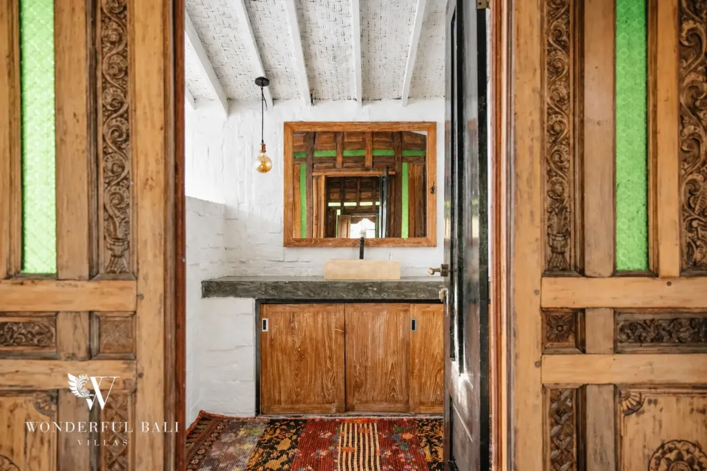 3BR villa for rent in Berawa, Canggu — bathroom 2, vanity set into a carved timber doorway