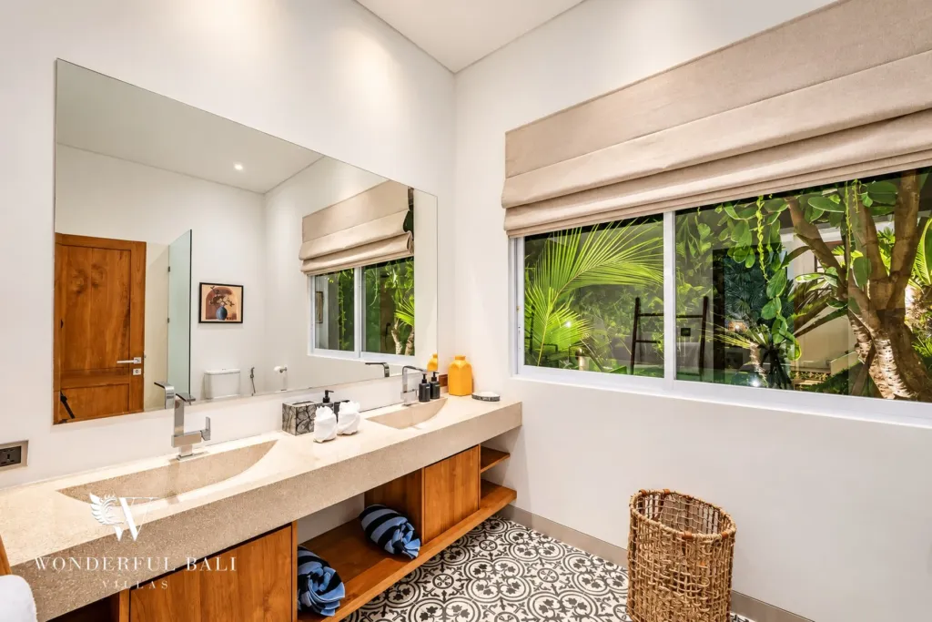 5BR villa for rent in Bumbak, Umalas — bathroom, double stone vanity with a garden window and cement floor tiles