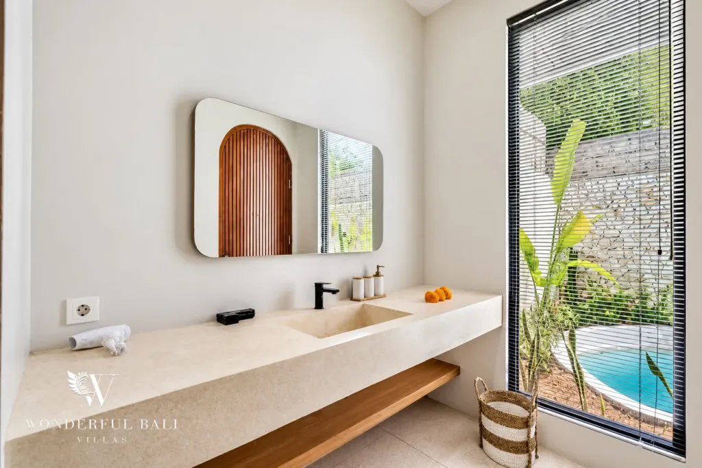 3BR villa for rent in Umalas, Bali — bathroom, vanity with a full-height window looking onto the pool