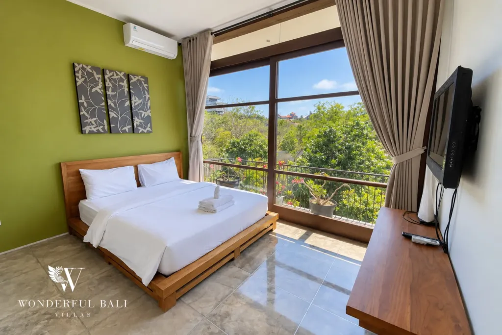 3BR villa for sale in Jimbaran — bedroom, bedroom with a green feature wall and balcony doors