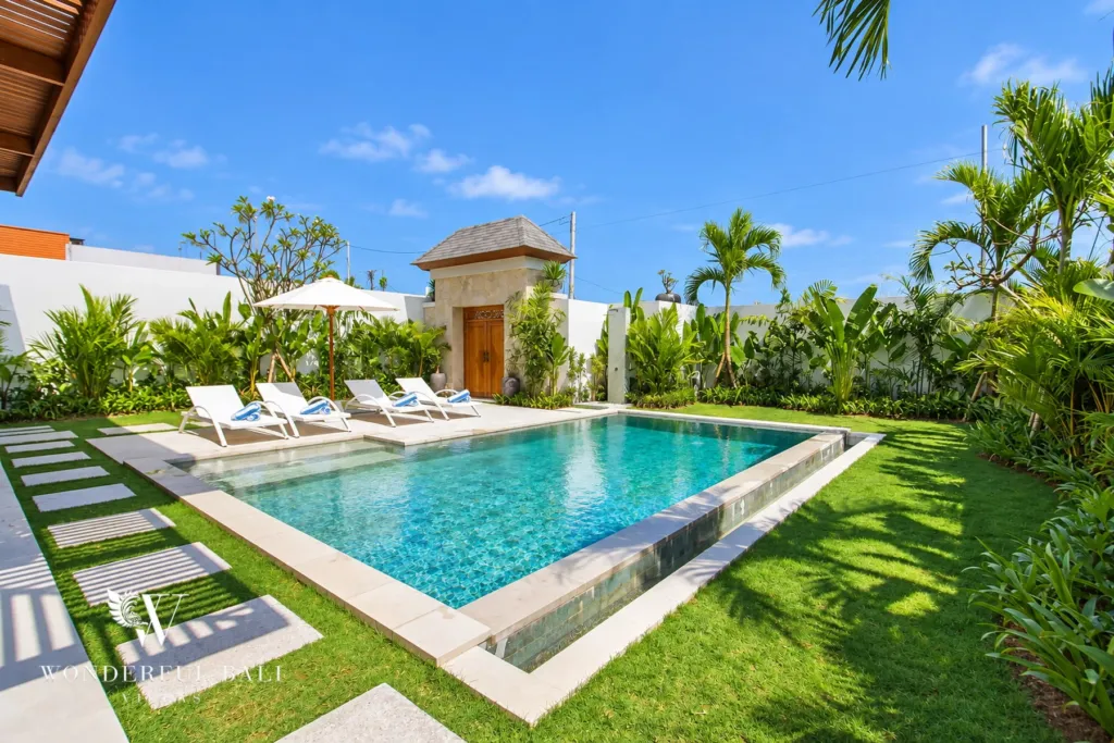 4BR villa for rent in Cemagi — pool, overflow pool, loungers and lawn toward the entrance gate
