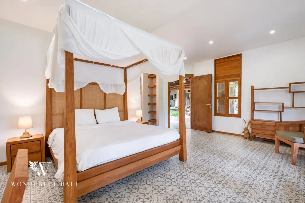 5BR villa for rent in Umalas — bedroom, four-poster bed, shelving and patterned tiles