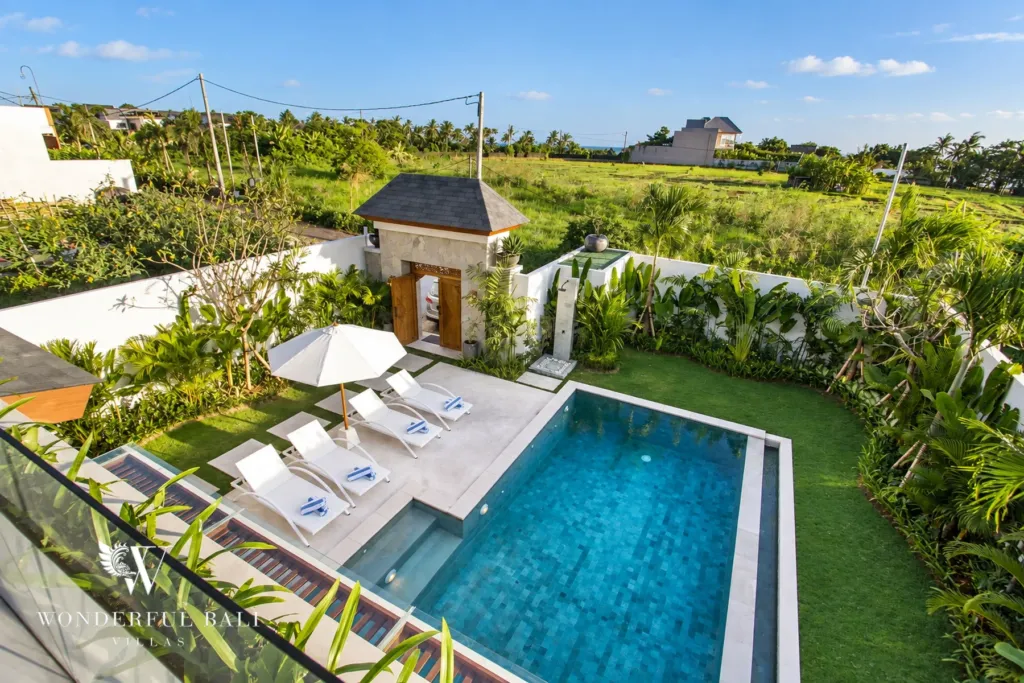 4BR villa for rent in Cemagi — pool, pool and garden with rice fields and ocean beyond