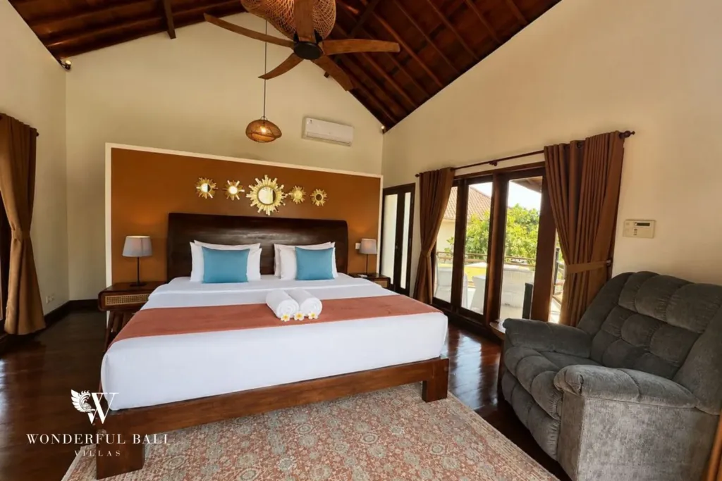 4BR villa for rent in Padonan, Canggu — bedroom 3, ground-floor bedroom with a terracotta feature wall