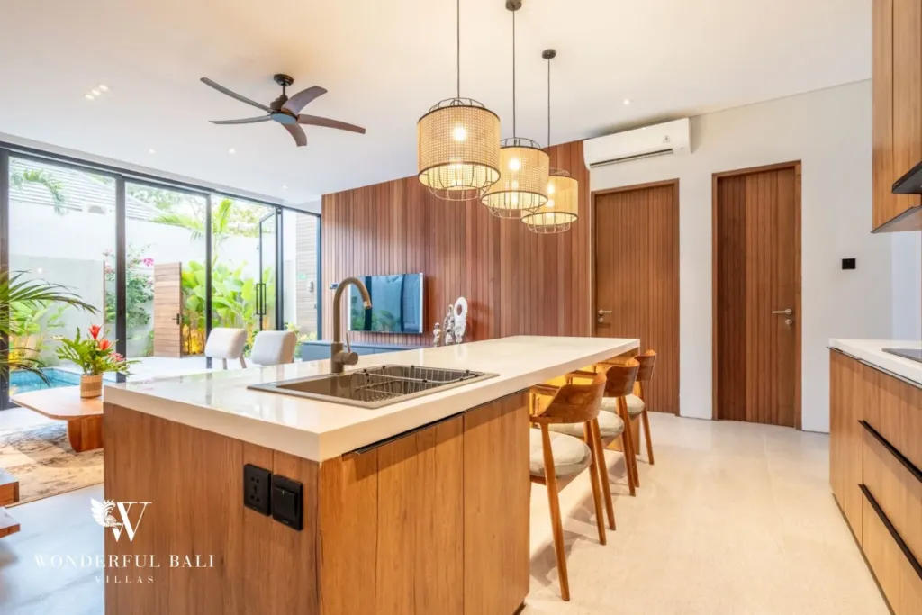 3BR villa for rent in Seminyak — kitchen, island and hob looking out to the pool