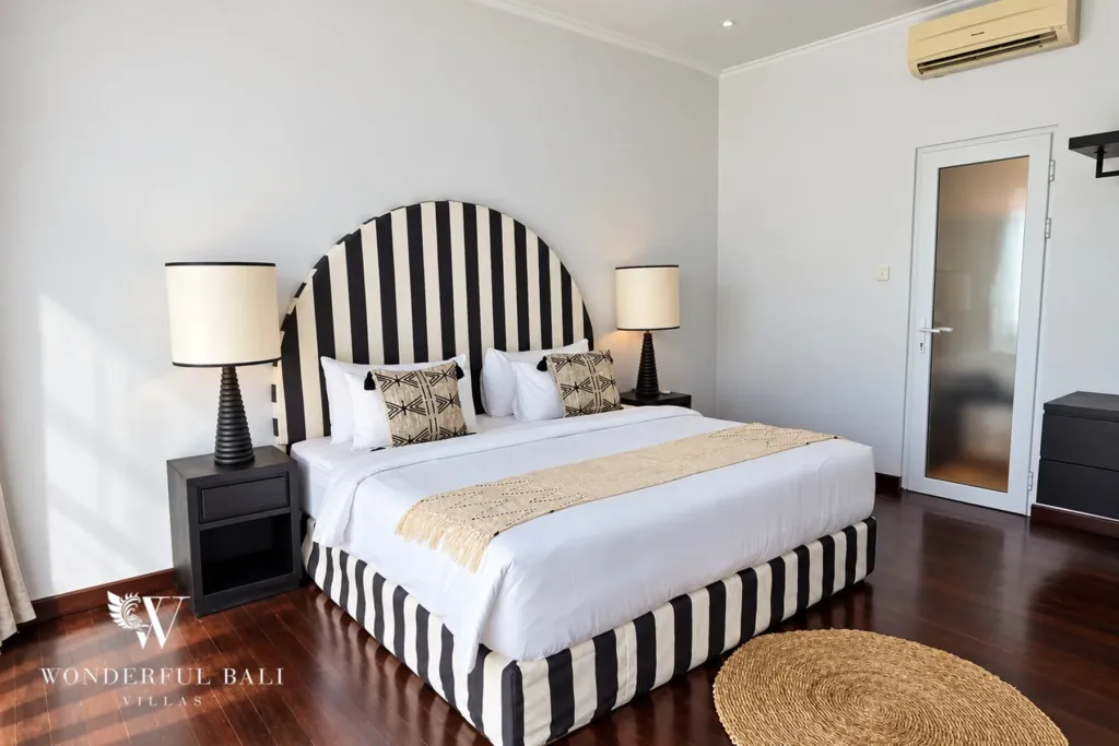 4BR villa for rent in Batu Bolong, Canggu — bedroom, bright double bedroom with striped headboard and jute rug