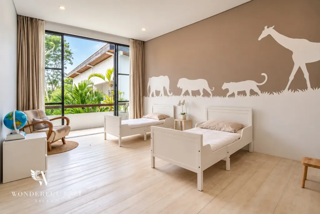 5BR villa for rent in Seseh, Bali — bedroom, children's bedroom with a soft pink wall, toys and a sofa
