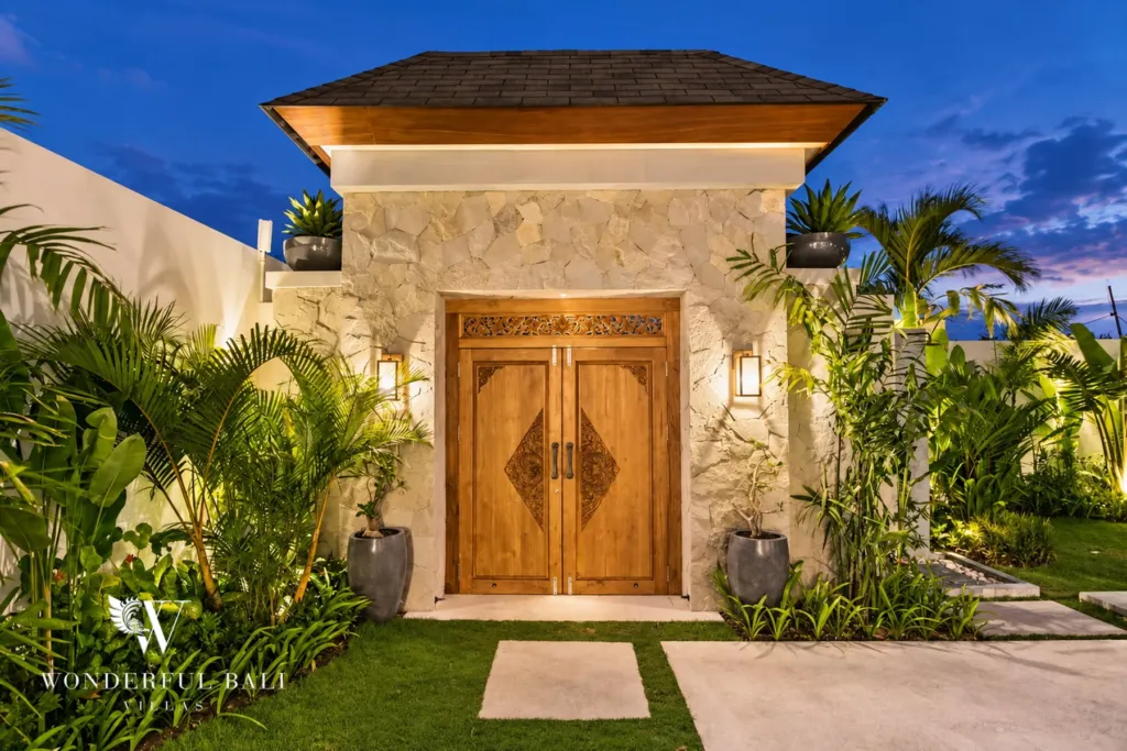 4BR villa for rent in Cemagi — entrance, lit stone gatehouse and garden path at dusk