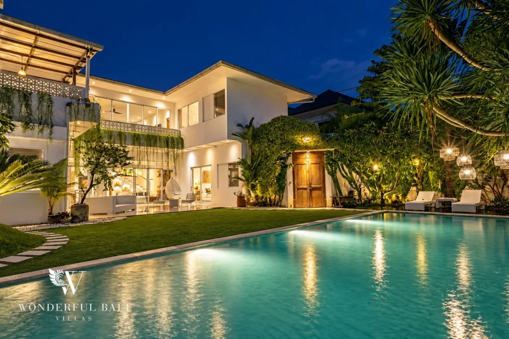 5BR villa for rent in Bumbak, Umalas — pool, the pool and villa at blue hour with the lawn lit along the edge