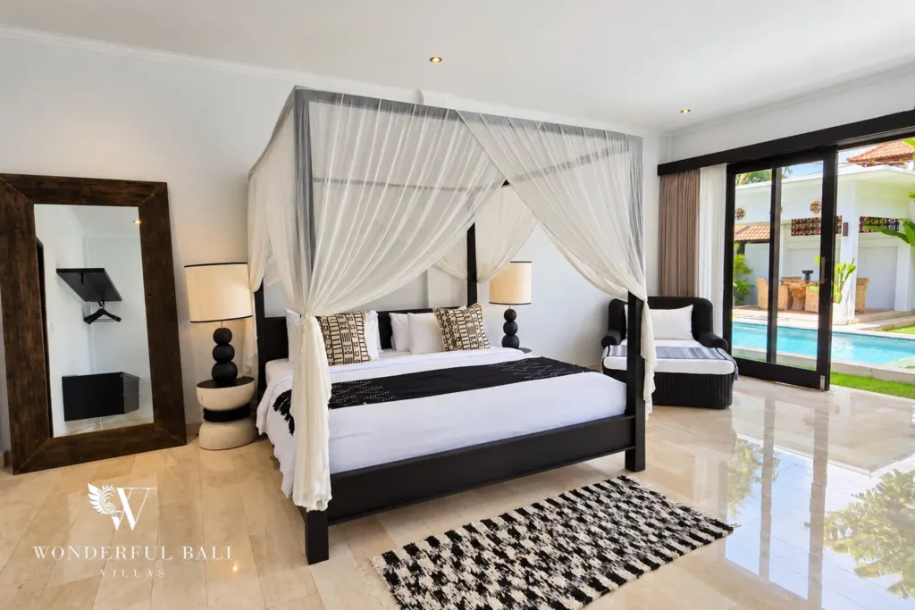 4BR villa for rent in Batu Bolong, Canggu — bedroom, canopy bed facing full-height doors onto the pool terrace