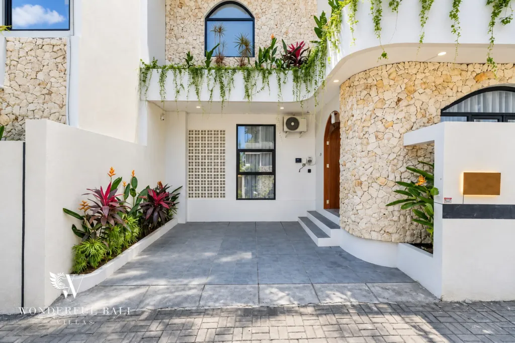 3BR villa for rent in Umalas, Bali — exterior, paved forecourt and curved stone wall at the main entrance
