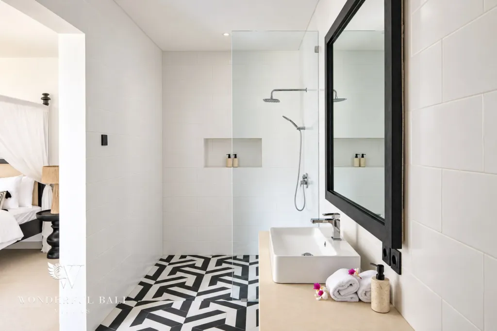 5BR villa for rent in Munggu, Bali — bathroom, vessel basin and mirror above a dark timber vanity