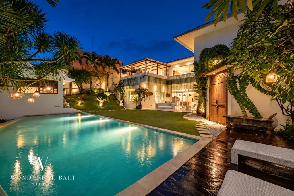 5BR villa for rent in Bumbak, Umalas — garden, night view across the pool to the lit garden and planting