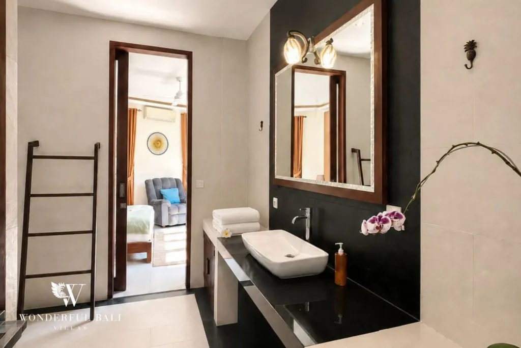 4BR villa for rent in Padonan, Canggu — shared bathroom, vanity with the bedroom beyond
