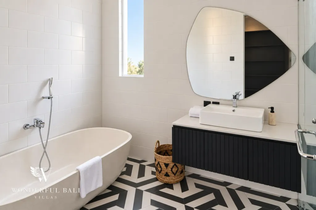 5BR villa for rent in Munggu, Bali — bathroom, bathtub and twin basins with a walk-in shower alongside