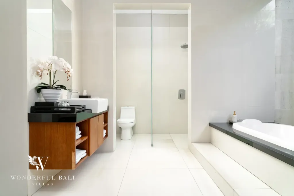 3BR villa for rent in Batu Belig, Seminyak — bathroom, twin vanity with a glass shower enclosure and bathtub beyond