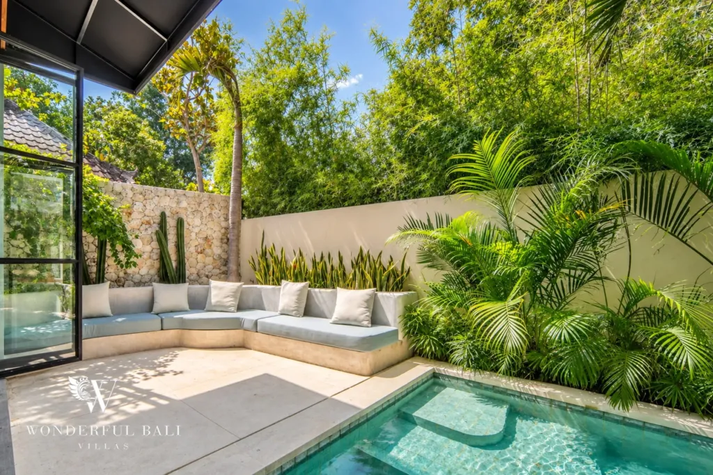 5BR villa for rent in Seseh, Bali — pool, sheltered corner of the pool behind a stone and planted wall
