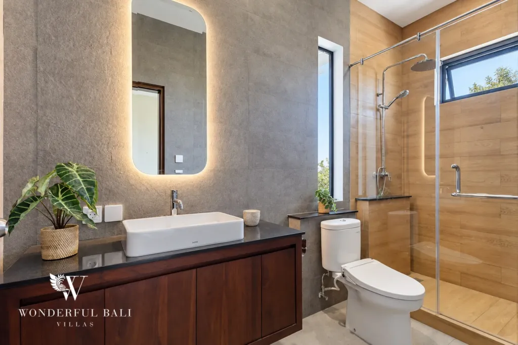 3BR villa for rent in Ungasan, Uluwatu — bathroom, stone basin and mirror in the en-suite