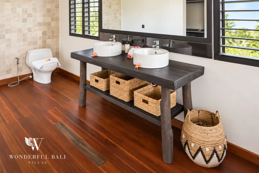 5BR villa for rent in Munggu, Bali — bathroom, double vanity on a timber console with woven storage baskets