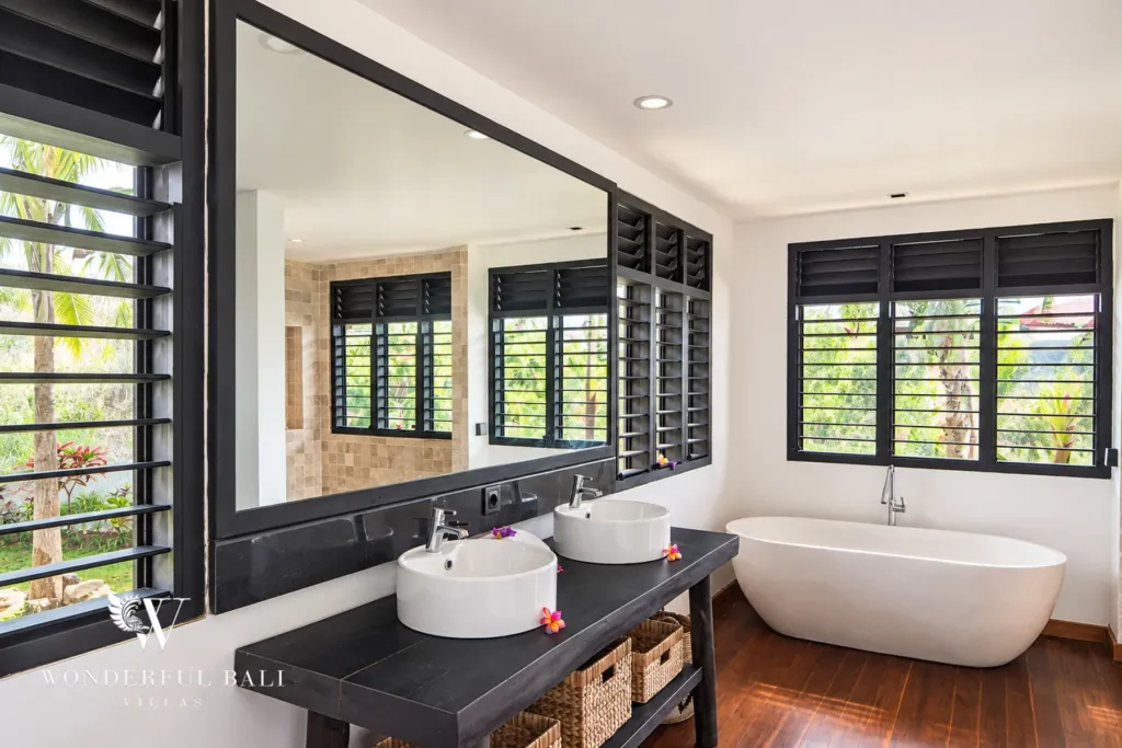 5BR villa for rent in Munggu, Bali — bathroom, wide view of the double vanity and freestanding tub by the window