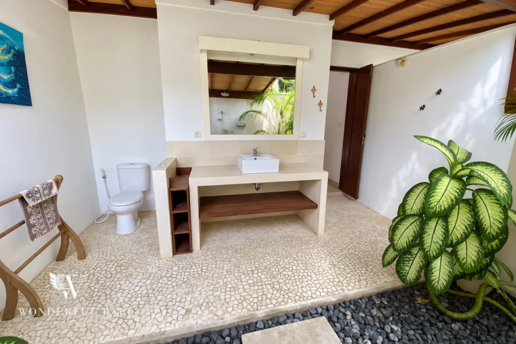 3BR villa for rent in Padonan, Canggu — bathroom, bathroom open to the sky with tropical planting and stepping stones