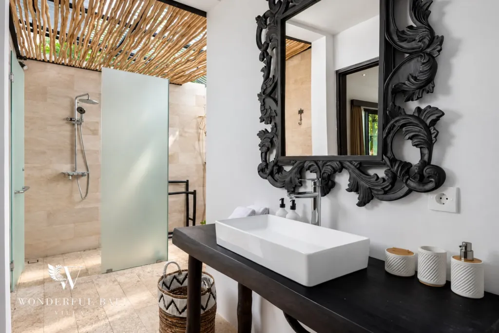 4BR villa for rent in Batu Bolong, Canggu — bathroom, vessel basin on a black console beside an open-air shower